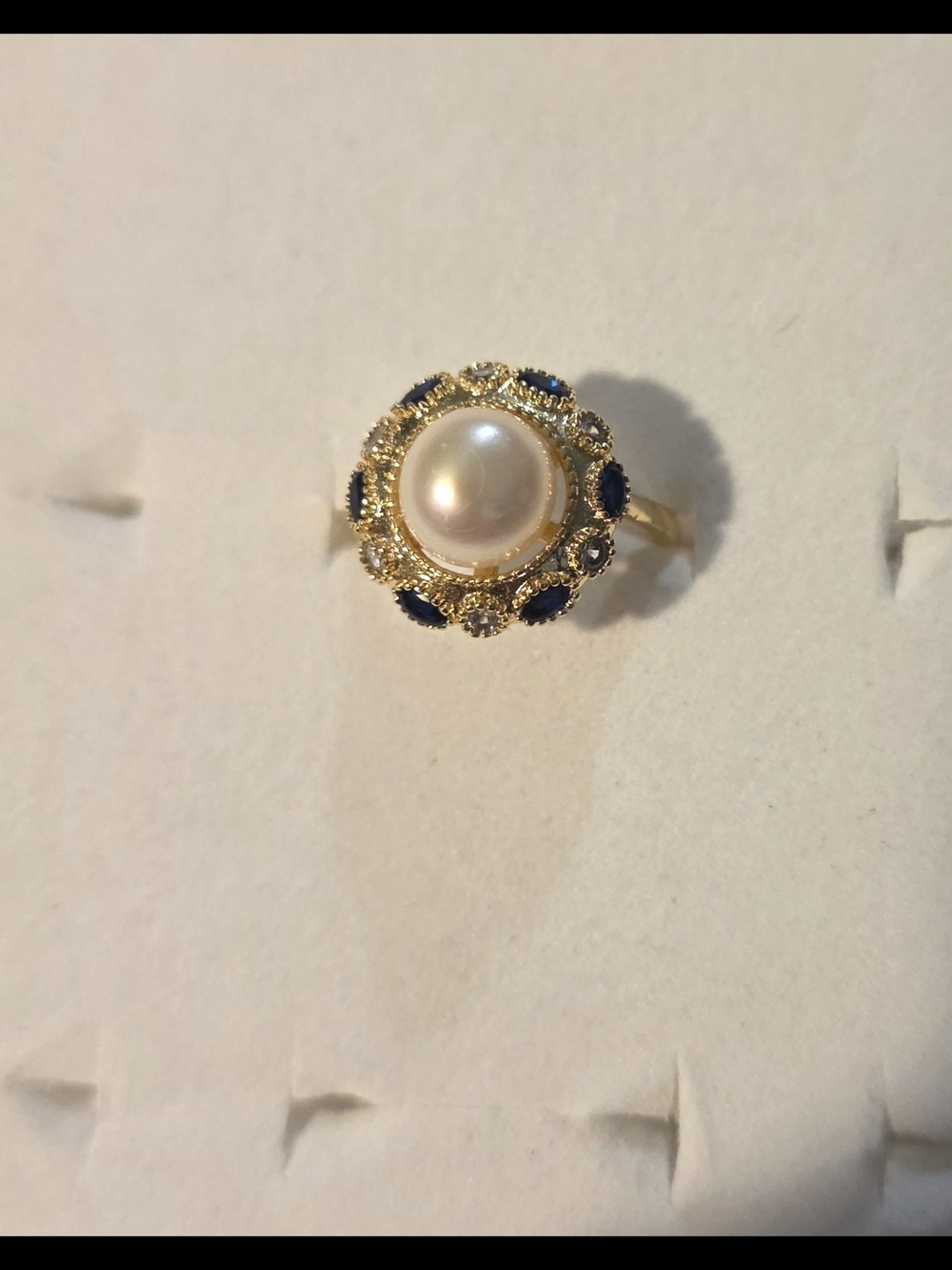 White Pearl and Blue Sapphire Halo Ring